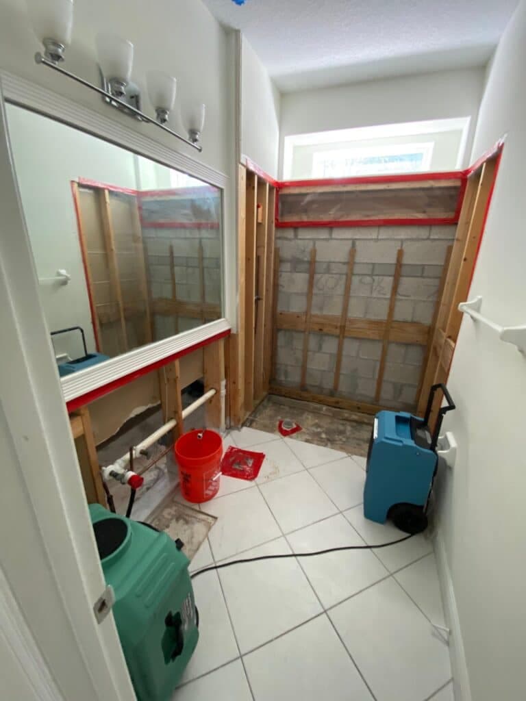 Bathroom demolition with drying equipment after water damage